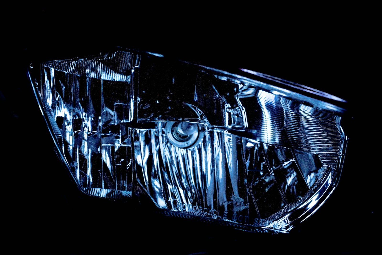 a close up of a car headlight in the dark